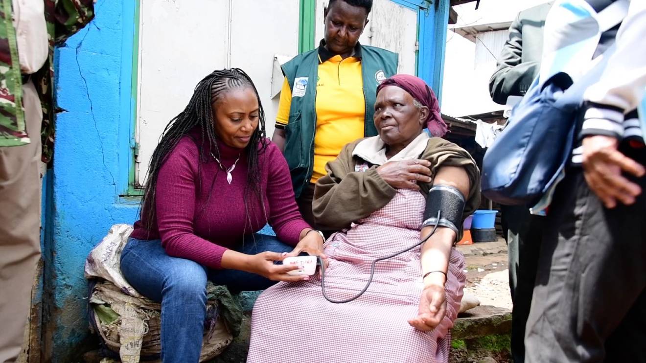 Mary Muthoni taking the vitals of a Kibera community member. PHOTO/COURTESY